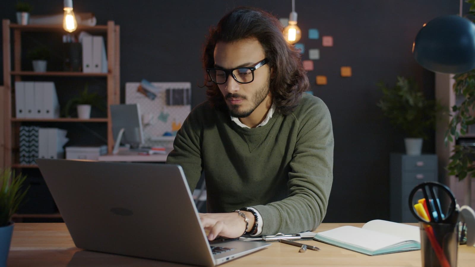 A business owner working at a laptop in a quiet office